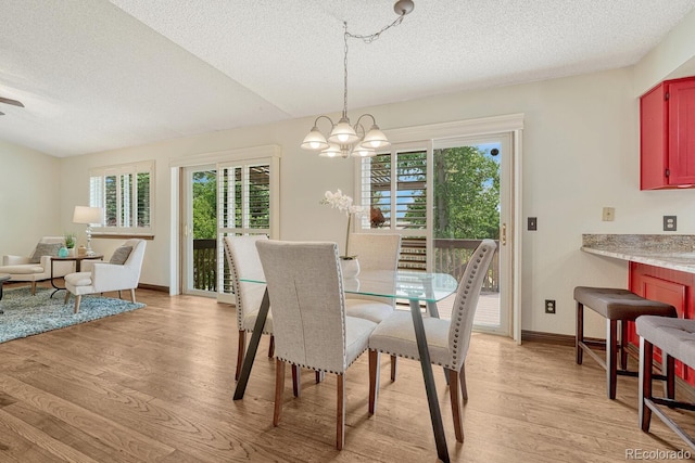 302 Northridge Rd, Highlands Ranch, CO 80126 - dining area featuring a textured ceiling, light wood-style flooring, a chandelier, and baseboards