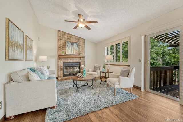 302 Northridge Rd, Highlands Ranch, CO 80126 - living area with a textured ceiling, ceiling fan, healthy amount of natural light, vaulted ceiling, and wood finished floors