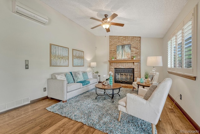 302 Northridge Rd, Highlands Ranch, CO 80126 - living room featuring an AC wall unit, a ceiling fan, a textured ceiling, wood finished floors, and vaulted ceiling
