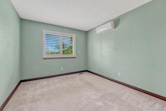 302 Northridge Rd, Highlands Ranch, CO 80126 - carpeted spare room featuring a wall unit AC, baseboards, a textured wall, and a textured ceiling