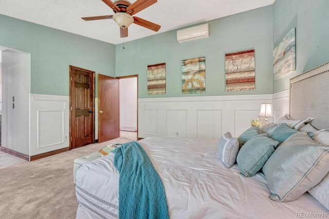 302 Northridge Rd, Highlands Ranch, CO 80126 - carpeted bedroom with a wall unit AC, a wainscoted wall, and a ceiling fan