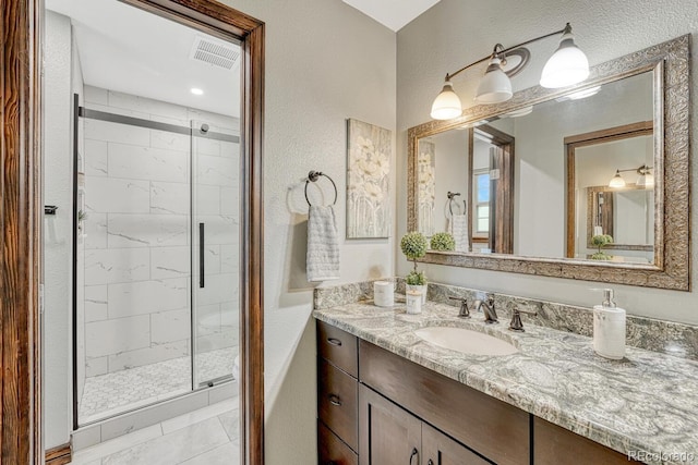 302 Northridge Rd, Highlands Ranch, CO 80126 - bathroom featuring a shower stall, vanity, and a textured wall
