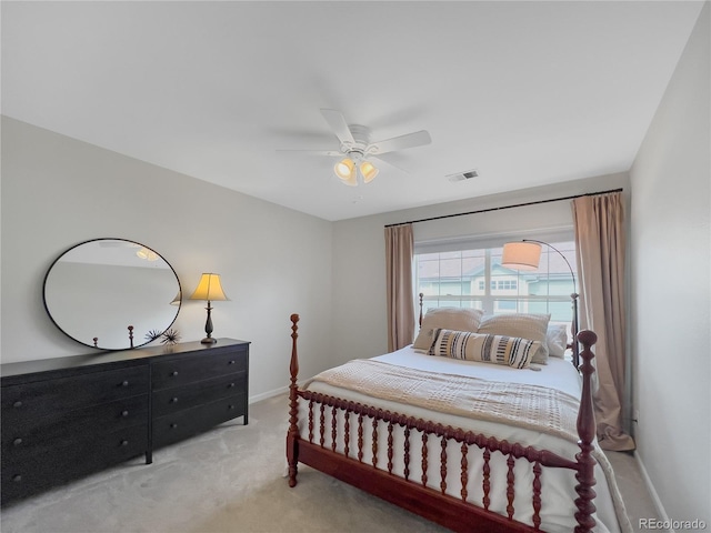 bedroom with baseboards, ceiling fan, visible vents, and light colored carpet