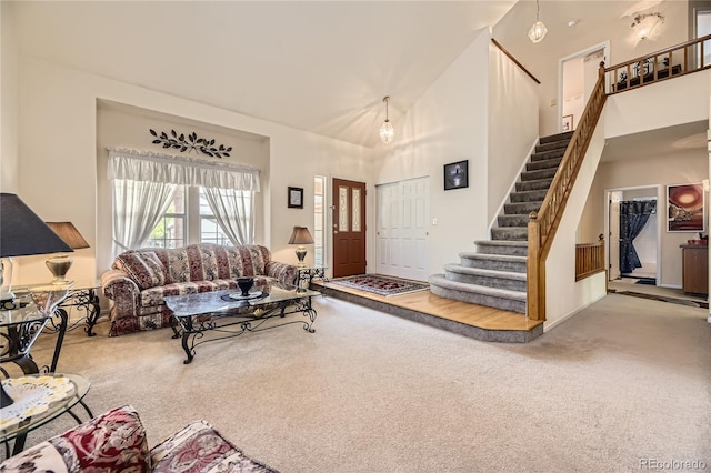 9001 W Chatfield Dr, Littleton, CO 80128 - carpeted living area featuring a towering ceiling and stairs