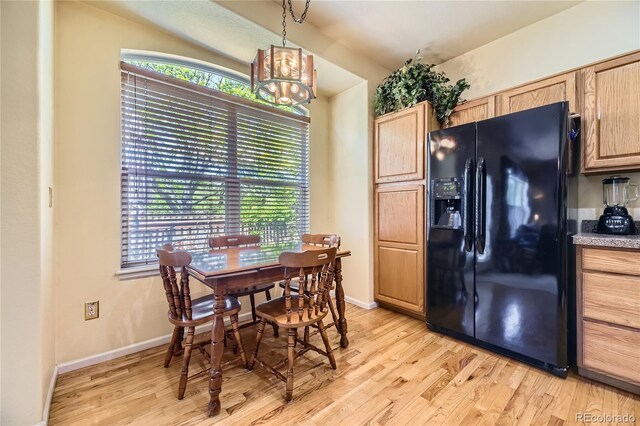 9001 W Chatfield Dr, Littleton, CO 80128 - dining room featuring light wood-type flooring, a chandelier, and baseboards