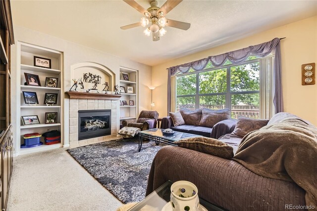 9001 W Chatfield Dr, Littleton, CO 80128 - carpeted living area featuring built in shelves, a fireplace, and ceiling fan