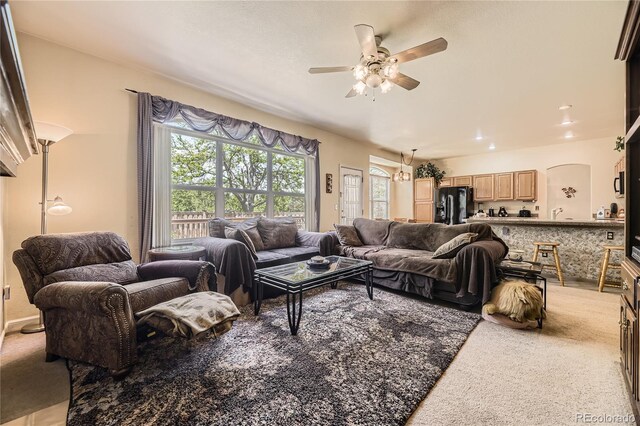 9001 W Chatfield Dr, Littleton, CO 80128 - living area featuring a ceiling fan, light carpet, arched walkways, and recessed lighting