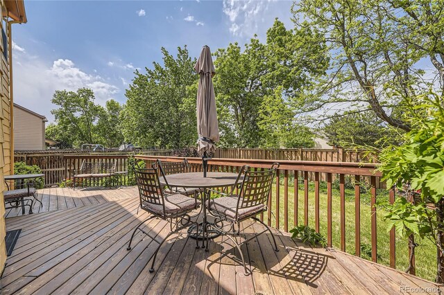 9001 W Chatfield Dr, Littleton, CO 80128 - wooden terrace featuring a fenced backyard and outdoor dining space