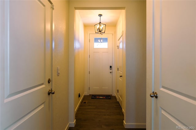 doorway featuring dark hardwood / wood-style floors and a chandelier