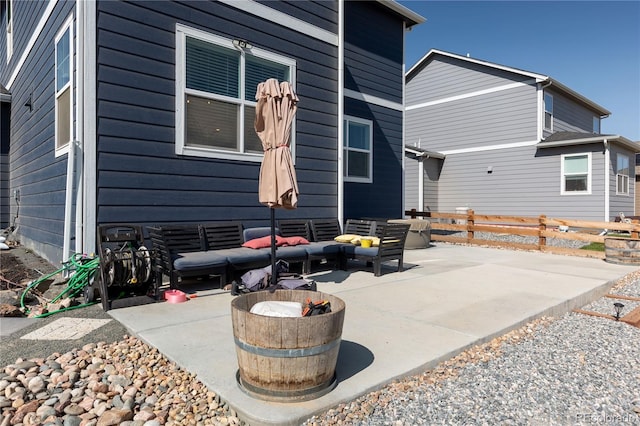 rear view of house with outdoor lounge area and a patio