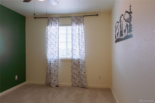 unfurnished room featuring light colored carpet and ceiling fan