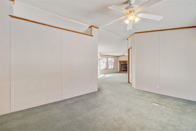 spare room with ceiling fan, light carpet, and a textured ceiling