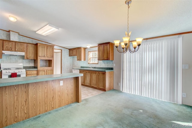 kitchen featuring decorative light fixtures, lofted ceiling, gas range gas stove, light carpet, and an inviting chandelier