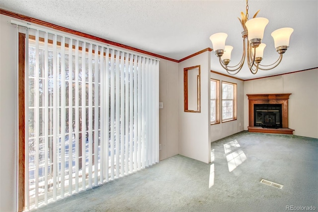 unfurnished living room featuring a notable chandelier, crown molding, a textured ceiling, and carpet flooring