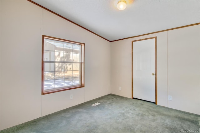 empty room with vaulted ceiling, light carpet, and crown molding