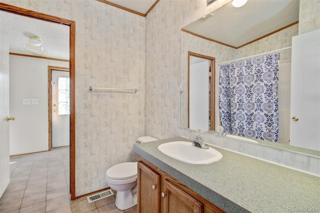 bathroom featuring vanity, toilet, crown molding, tile patterned floors, and a textured ceiling