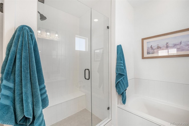 full bathroom with a bath and a shower stall
