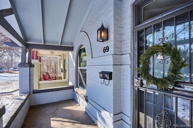 property entrance featuring brick siding