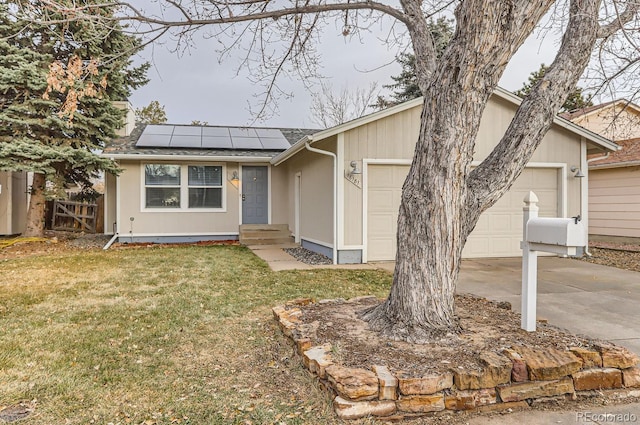 ranch-style home featuring a front lawn, a garage, and solar panels