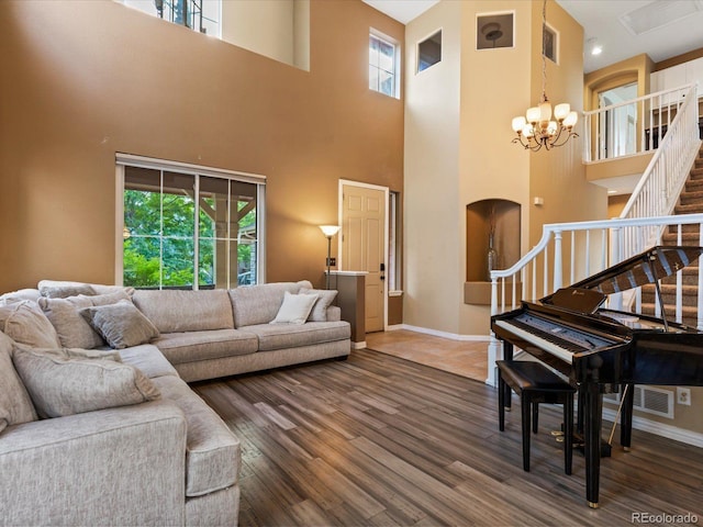 10216 Kleinbrook Way, Highlands Ranch, CO 80126 - living room featuring stairway, a chandelier, arched walkways, a towering ceiling, and plenty of natural light