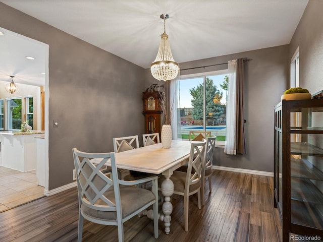10216 Kleinbrook Way, Highlands Ranch, CO 80126 - dining room with a chandelier, wood finished floors, healthy amount of natural light, and recessed lighting