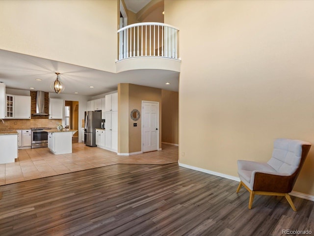 10216 Kleinbrook Way, Highlands Ranch, CO 80126 - living room with wood finished floors, a towering ceiling, and recessed lighting