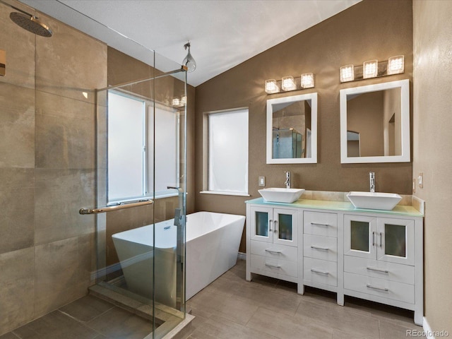 10216 Kleinbrook Way, Highlands Ranch, CO 80126 - bathroom with a stall shower, lofted ceiling, a freestanding tub, double vanity, and tile patterned floors