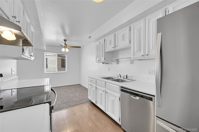 kitchen featuring sink, white cabinets, stainless steel appliances, and light hardwood / wood-style floors