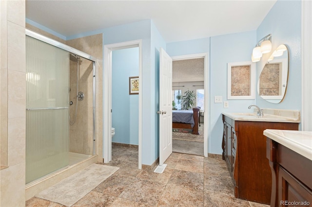 bathroom featuring toilet, walk in shower, and vanity