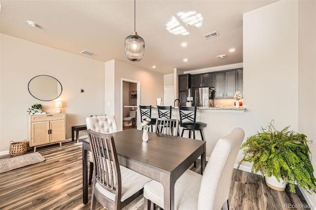 dining space featuring recessed lighting, visible vents, baseboards, and wood finished floors