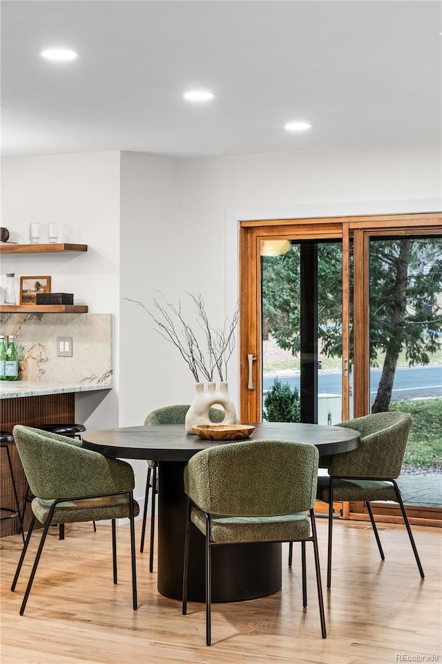 dining space featuring breakfast area, light wood-style floors, and recessed lighting