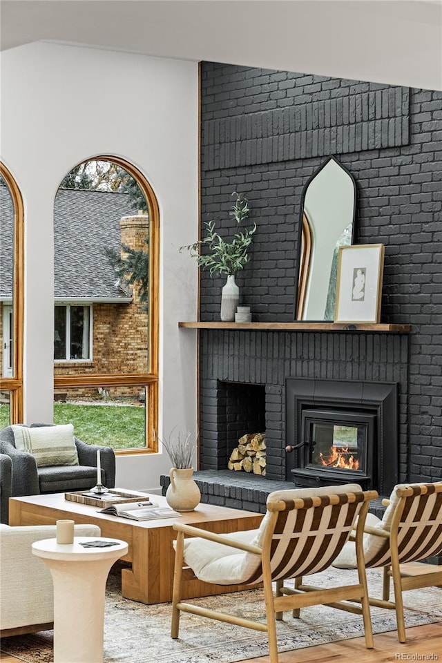 sitting room with a fireplace and wood finished floors