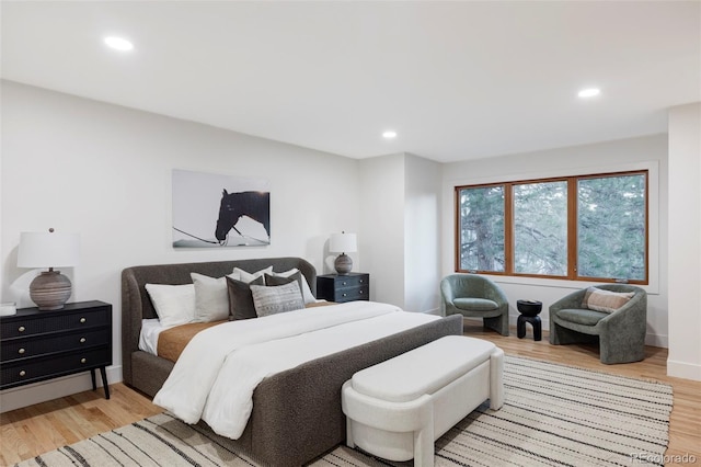 bedroom featuring light wood-type flooring and recessed lighting
