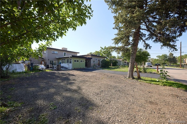 1075 S Ames St, Lakewood, CO 80226 - view of front of property with driveway and stucco siding