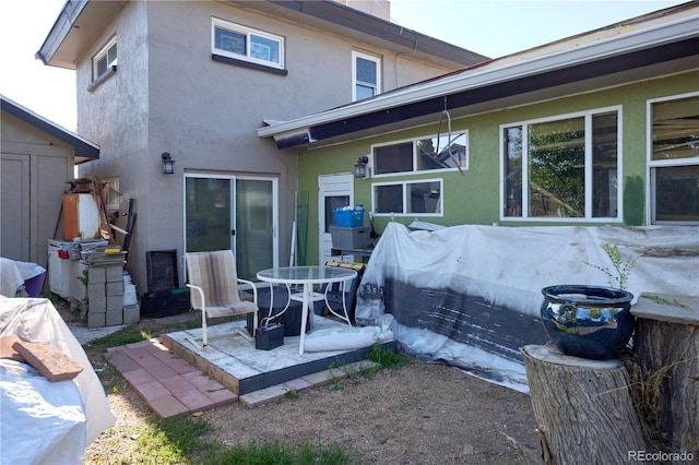 1075 S Ames St, Lakewood, CO 80226 - back of house featuring stucco siding and a patio area