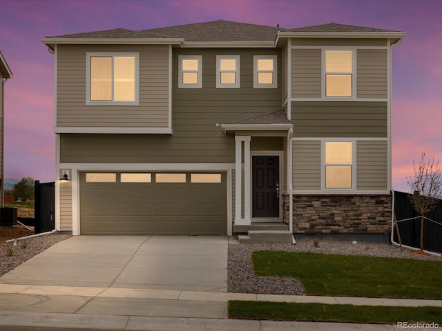 view of front of property featuring a garage, concrete driveway, central AC, stone siding, and fence