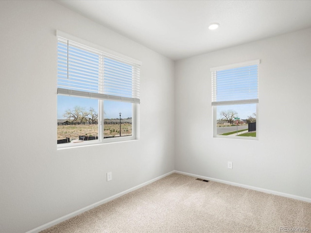 carpeted spare room with baseboards and recessed lighting