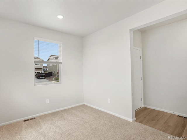 carpeted empty room with baseboards and recessed lighting