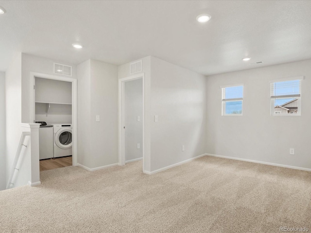 empty room featuring washing machine and clothes dryer, carpet flooring, baseboards, and recessed lighting