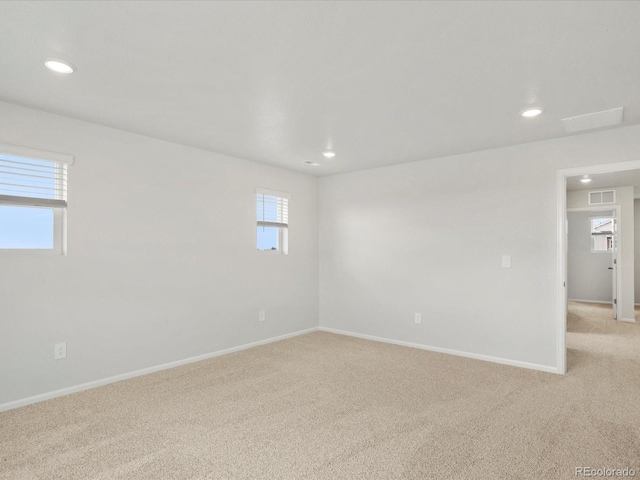 carpeted spare room with recessed lighting and baseboards