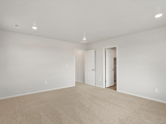 unfurnished room featuring carpet, recessed lighting, and baseboards