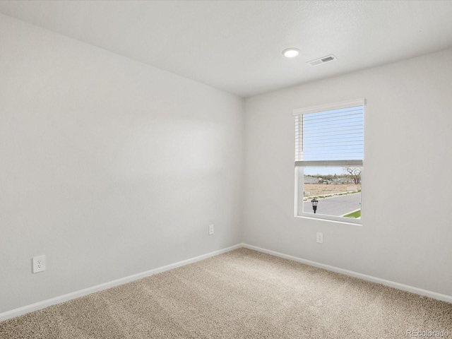 carpeted spare room with baseboards