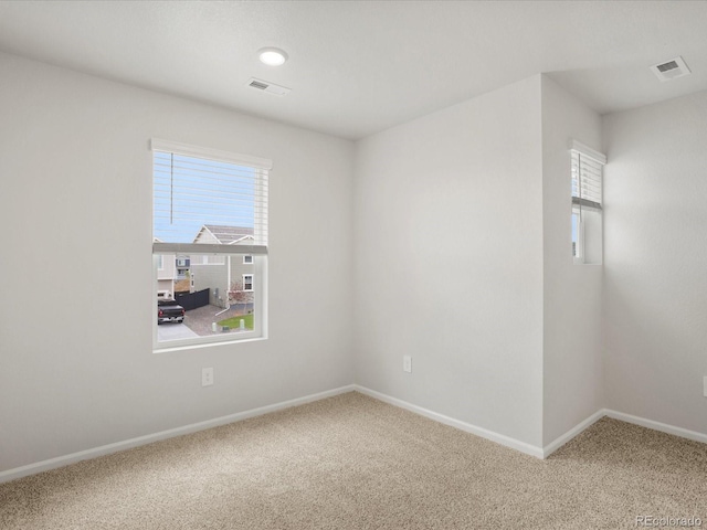 carpeted spare room with baseboards