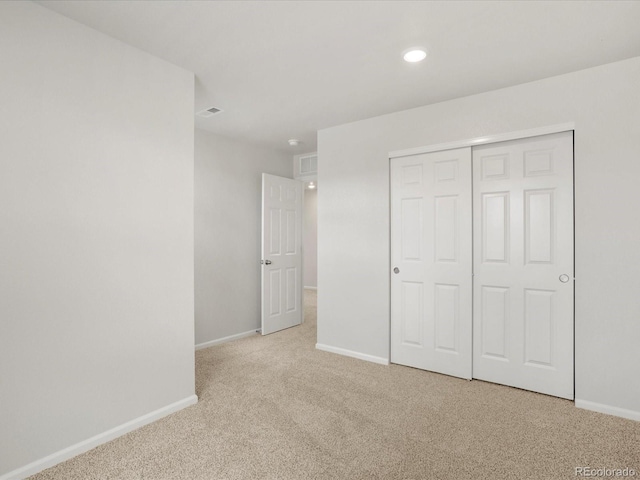 unfurnished bedroom with carpet floors, baseboards, a closet, and recessed lighting