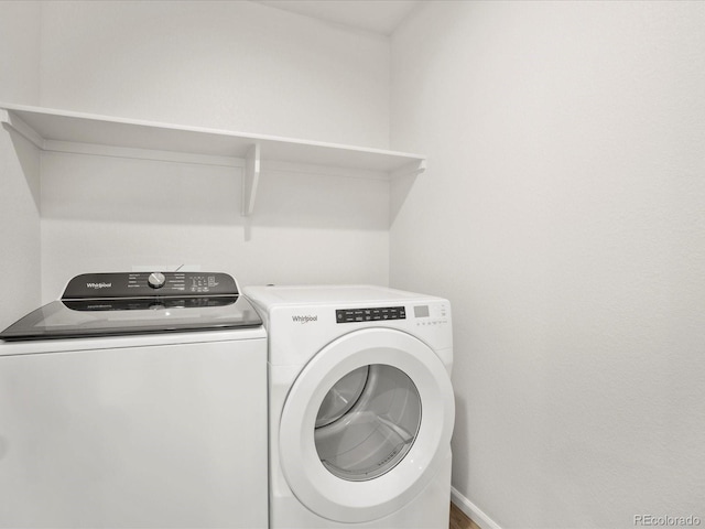 washroom featuring separate washer and dryer and baseboards