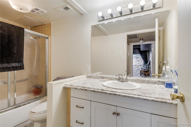 full bathroom featuring shower / bath combination with glass door, oversized vanity, and toilet