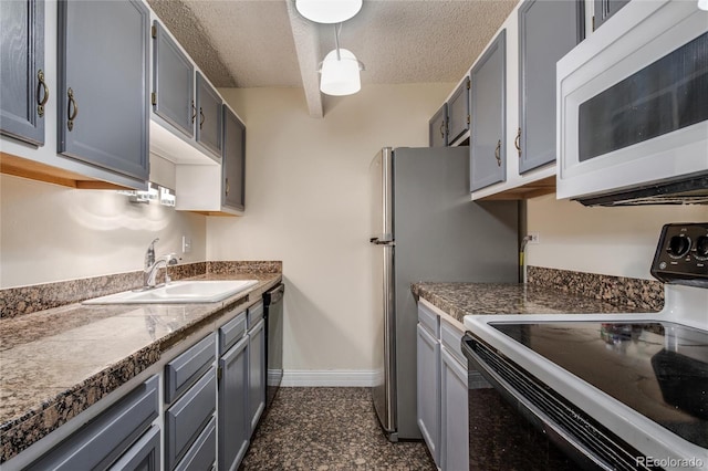 kitchen with decorative light fixtures, white appliances, gray cabinetry, and a textured ceiling