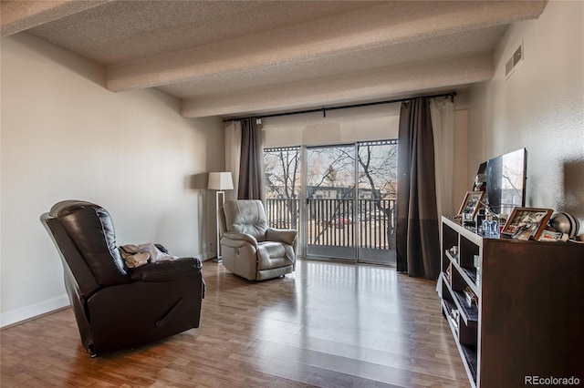 sitting room featuring hardwood / wood-style floors and a textured ceiling