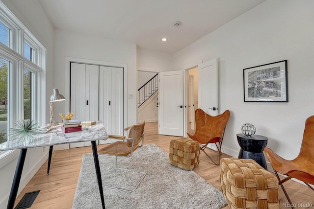 sitting room with stairs, light wood-style flooring, baseboards, and recessed lighting