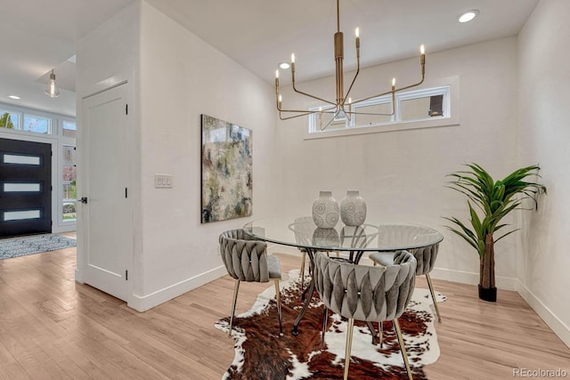 dining area featuring baseboards, light wood finished floors, a chandelier, and recessed lighting